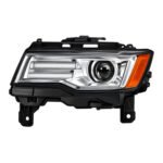 Grand Cherokee chrome-surround HID headlight with horizontal inner sections, circular projector and amber outer area