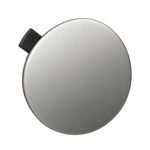 Compass front bumper tow-hook cover with a smooth oval face and a rectangular retaining tab at the edge